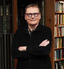 James A Robinson in front of bookcase
