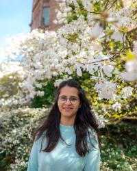 Smiling woman in front of flowering cherry tree