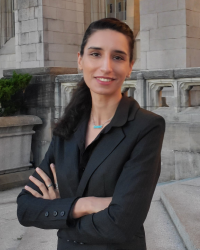 woman with black blazer arms crossed