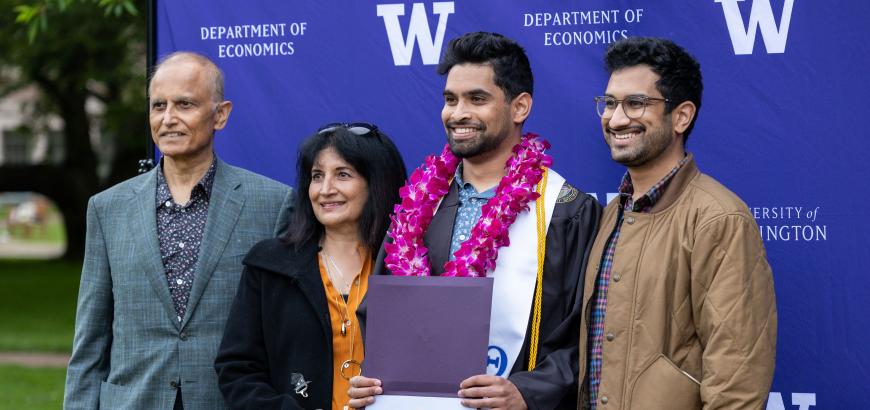 A graduate and family, at the Economics Graduation Celebration