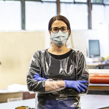 Women standing with hands crossed in a hospital gown for health workers